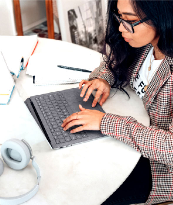 Girl working on computer Lady looking at website made by One Source Web Development
